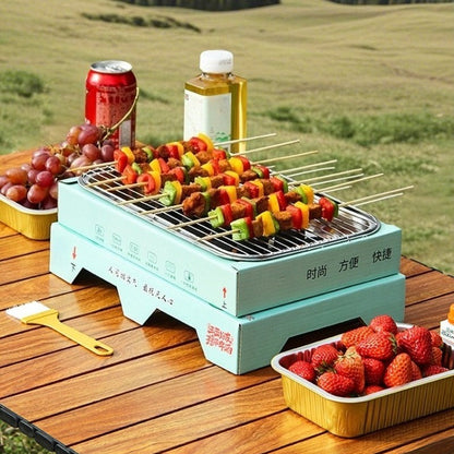 Portable grill with skewered vegetables on a wooden table outdoors